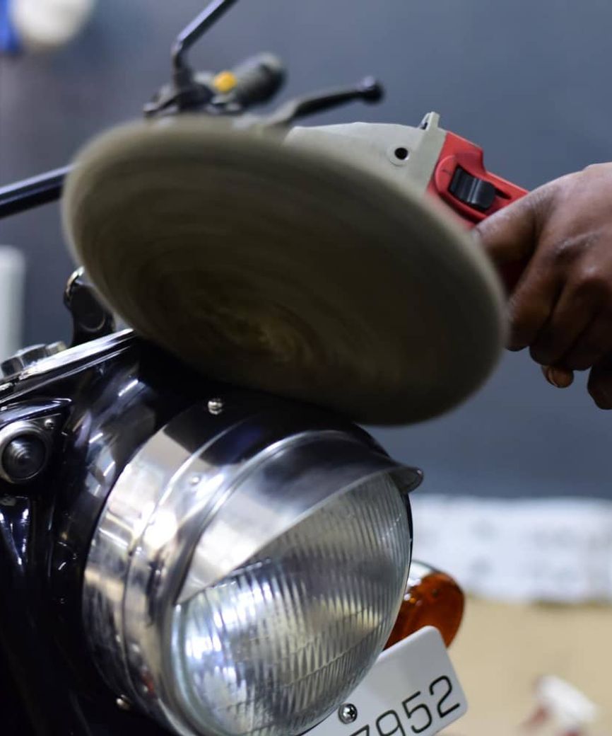 motorcycle detailing being done on headlight